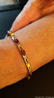 Amber and sterling silver bracelet worn on wrist to show fit and appearance.