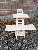 Full view of wooden sit stand workstation with two platforms at adjustable heights.