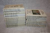 Two stacks of Beatrix Potter books with titles clearly visible showing duplicates.