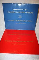 Blue and red portfolios with gold embossed titles in English and French, giving the series name 'Gallery of Canadian History' by Confederation Life.