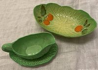 Dishes arranged side-by-side showing green leaf shapes and orange tomato decoration.
