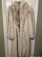 Front view of coat on hanger against door