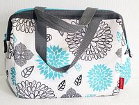 Front and top view of Thermos insulated lunch bag with floral pattern and gray handles.