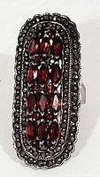 Front view of vintage sterling silver dinner ring showing garnet and marcasite stones in rectangular setting.