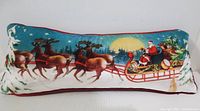 Front view of the entire plush velvety Christmas cushion cover with Santa Claus in sleigh and reindeer in snowy scene.