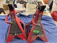 Two Big Red red metal jack stands with 6-ton capacity, showing surface wear and dirt