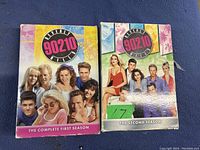 Photo of two DVD cases showing Beverly Hills 90210 complete first and second seasons.