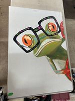 Close-up of the frog's face and glasses, showing vibrant colors and details.
