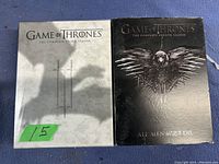 Photo showing DVD sets for Game of Thrones Seasons 3 and 4 placed side by side with visible cover art and condition.