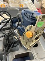 Ryobi biscuit jointer showing the blue motor casing, metal base plate, adjustable angle dial, and power cord.