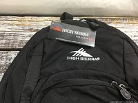 Close up photo showing High Sierra brand tag on backpack