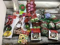 Photo showing assorted Christmas-themed cookie cutters, baking cups, and foil candy cups, all new in original packaging.