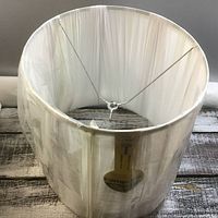 Front angled view of Lampolite lamp shade showing fabric texture, metal frame, and brand tag.