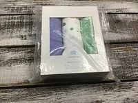 Packaged set of three muslin cotton blankets from Cloud Island, visible through the box window showing a purple, a white printed, and a green blanket.