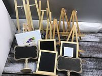 14 wooden craft pieces including easels and framed chalkboards, arranged on rustic wood surface