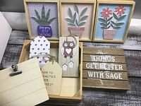 Frontal view of all wood craft items including framed pictures, owl decoration, wooden tags, clipboard piece, and block sign.