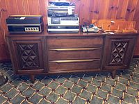 Front view of entire dresser with stereo components on top