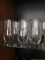 Ten 5 1/2 inch tall clear glasses with a slightly rounded rectangular profile