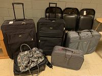 Wide shot of all suitcases and bags together showing sizes and types.