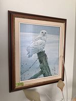 Framed print of a snow owl perched on a wooden post in a snowy landscape, titled Ready for the Hunt by Robert Bateman.