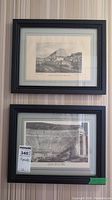Front view photo showing both vintage framed engravings hanging on a striped wall. The upper engraving depicts a mountain village, the lower shows an amphitheater.