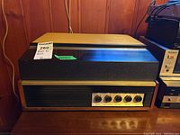 Front view of the Philips Continental 420 reel to reel tape deck with visible control knobs and wood paneling.