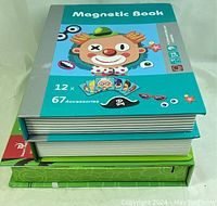 Three hardcover magnetic puzzle books stacked, showing colorful covers and puzzle counts.