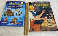 Photo of two large hardcover children's books side by side, with a ruler for scale. One is Pinocchio, the other is Disney's 365 Bedtime Stories.