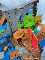 Close-up of the pirate ship with red sails and wooden deck, part of the 3D pirate playset.