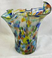 Front angled view showing overall shape and colorful dot pattern of glass vase.