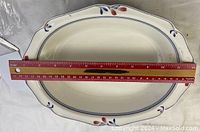Top view of Noritake Copper Bud oval serving bowl with measuring ruler showing length of approximately 13 inches.