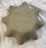 Bottom of ceramic tart pan showing Pampered Chef imprint and size (10 in)