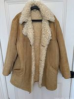 Full front view of men's Morlands shearling sheepskin coat showing tan suede exterior and plush cream shearling lining and collar.