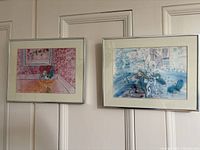 Two lithograph prints by Raoul Dufy hanging side by side framed.