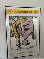 Front view of framed poster against wall showing full image and condition