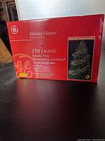Photo of the product box showing GE Holiday Classics branding and product name: 150 Lights Grape Vine Decorating Garland