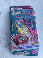 Front of box showing colorful art of transforming robot and vehicle