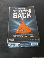Front of the new You Lying Sack party game box showing artwork and game title.