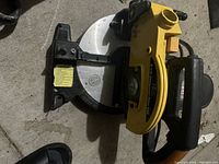 Top view of a yellow and black 6 3/4 inch mitre saw showing blade, handle, and base.