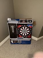 Front view of boxed EastPoint Essex bristle dartboard and cabinet with chalk scoreboard visible on door.