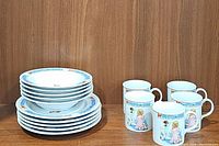 Set of 5 bowls stacked, 5 plates stacked and 5 cups arranged