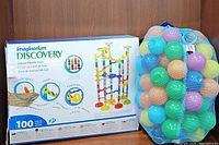 Boxed Imaginarium Discovery Deluxe Marble Race building set and mesh bag of colorful play balls