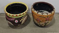 Both decorated planters side by side showing design and form.