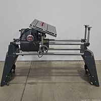 Side view of entire Shopsmith machine mounted on wheeled stand, showing table and rail assembly