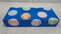 Original bright blue box with color circle outlines of Disney characters and text 'DISNEY CHARACTERS GLASS SET'