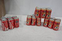 Photo showing all unopened Coke cans including Orioles Camden Yards, Redskins, and standard Coca-Cola.