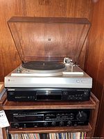 Front view of the stack showing the Dual CS-508 turntable on top with dust cover, Sony CDP-XE300 CD player below, and Denon DRA-435-R receiver at the bottom