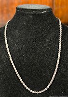 Full-length view of chain draped on display bust