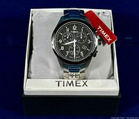 Watch displayed in branded Timex box on gray cushion