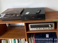 Wooden shelf holding three components: turntable, CD changer and receiver below